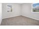 Cozy bedroom with plush carpeting, neutral paint, and bright natural light from large windows at 4062 Doster Sw Dr, Atlanta, GA 30331