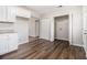 Functional kitchen space with white cabinets, granite countertops, and a separate laundry area at 4062 Doster Sw Dr, Atlanta, GA 30331