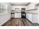 Well-lit kitchen with stainless steel appliances, granite countertops, and classic white cabinetry at 4062 Doster Sw Dr, Atlanta, GA 30331