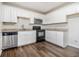 Modern kitchen featuring stainless steel appliances, granite countertops, and white cabinets at 4062 Doster Sw Dr, Atlanta, GA 30331
