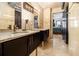 Bathroom showcasing dual sinks, granite countertops, and marble tile flooring at 795 Hammond 1013 Dr, Sandy Springs, GA 30328
