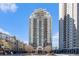 Full exterior shot of the building featuring a beige facade and private balconies in a modern design at 795 Hammond 1013 Dr, Sandy Springs, GA 30328
