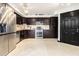 A modern kitchen features stainless steel appliances, dark cabinets, and sleek tile flooring at 795 Hammond 1013 Dr, Sandy Springs, GA 30328