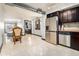 Bright kitchen with stainless steel appliances, dark cabinets, and dining chairs on tile floors at 795 Hammond 1013 Dr, Sandy Springs, GA 30328