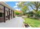 Expansive deck leads to a lush backyard with a basketball court, water feature, and mature landscaping at 417 Lynne Cir, Alpharetta, GA 30009