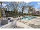 Lush backyard featuring a pool, patio, and water feature, offering an ideal space for outdoor gatherings at 417 Lynne Cir, Alpharetta, GA 30009