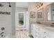 Bright bathroom featuring double vanity, decorative mirrors, and a walk-in shower at 417 Lynne Cir, Alpharetta, GA 30009