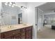 Double vanity bathroom featuring a large mirror and lighting, and view to the main bedroom area at 417 Lynne Cir, Alpharetta, GA 30009