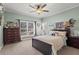 Cozy bedroom featuring a comfortable bed, ceiling fan and decorative wall art at 417 Lynne Cir, Alpharetta, GA 30009