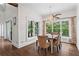 Elegant dining room with hardwood floors, and a chandelier, complemented by views from the multiple large windows at 417 Lynne Cir, Alpharetta, GA 30009