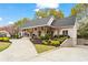 Charming home featuring a covered front porch, manicured landscaping, and convenient driveway access at 417 Lynne Cir, Alpharetta, GA 30009