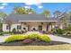 Stunning one-story home with a covered front porch, beautifully landscaped front yard, and paved driveway at 417 Lynne Cir, Alpharetta, GA 30009