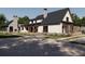 Elegant home featuring a brick chimney, modern architectural lines, and a sprawling driveway at 417 Lynne Cir, Alpharetta, GA 30009