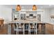 Beautiful kitchen with large island, stainless steel appliances, and unique decorative backsplash and wooden accents at 417 Lynne Cir, Alpharetta, GA 30009