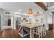 Modern kitchen with a large island, stainless steel appliances, and hardwood floors, open to other living areas at 417 Lynne Cir, Alpharetta, GA 30009