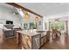 Open-concept kitchen featuring an island, farm sink, stainless steel appliances, and view to living area at 417 Lynne Cir, Alpharetta, GA 30009