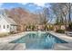 Beautiful backyard pool with lounge chairs, pool house, and basketball court, perfect for entertaining at 417 Lynne Cir, Alpharetta, GA 30009