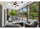 Relaxing sunroom featuring comfortable seating with views of the landscaped backyard and water feature at 417 Lynne Cir, Alpharetta, GA 30009