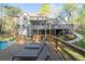 Backyard featuring a wooden deck, lounge chairs, and lush green landscaping at 608 Apache Trl, Woodstock, GA 30189