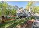 Beautiful backyard featuring a deck, swimming pool and surrounding trees at 608 Apache Trl, Woodstock, GA 30189