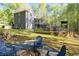 A spacious backyard area with a firepit, outdoor seating, and a well-maintained lawn at 608 Apache Trl, Woodstock, GA 30189