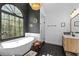 Beautiful bathroom featuring a soaking tub with views and a tiled shower at 608 Apache Trl, Woodstock, GA 30189