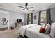 Bright bedroom features a ceiling fan, desk, neutral walls, and windows offering natural light at 608 Apache Trl, Woodstock, GA 30189