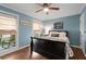 Cozy bedroom featuring hardwood floors, a ceiling fan, and natural light from two windows at 608 Apache Trl, Woodstock, GA 30189