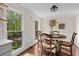 Cozy dining area with hardwood floors and views of the surrounding greenery through bright windows at 608 Apache Trl, Woodstock, GA 30189