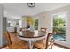 Bright dining area featuring hardwood floors and a window overlooking an inground pool at 608 Apache Trl, Woodstock, GA 30189