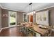 Elegant dining room with hardwood floors, statement lighting, and a large cabinet at 608 Apache Trl, Woodstock, GA 30189