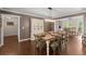 Spacious dining room with hardwood floors, neutral paint, and statement chandelier at 608 Apache Trl, Woodstock, GA 30189