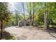 A secluded home nestled among mature trees, featuring a long driveway and well-maintained landscaping for a serene setting at 608 Apache Trl, Woodstock, GA 30189