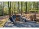 Outdoor firepit area with chairs and ample seating, nestled among the trees at 608 Apache Trl, Woodstock, GA 30189