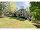 Beautiful home with a well-manicured lawn and mature trees, showcasing its inviting front porch and classic architecture at 608 Apache Trl, Woodstock, GA 30189