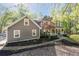 Attractive house with a welcoming front porch, complemented by lush landscaping and a beautiful tree in the front yard at 608 Apache Trl, Woodstock, GA 30189