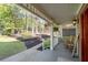 Charming covered front porch with classic rocking chairs and peaceful views of the landscaped front yard and mature trees at 608 Apache Trl, Woodstock, GA 30189