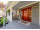 Inviting front porch with wood door, featuring rocking chairs and charming decor for a warm and friendly welcome at 608 Apache Trl, Woodstock, GA 30189