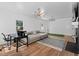 Bright living room featuring modern lighting, hardwood floors, and a cozy sitting area at 608 Apache Trl, Woodstock, GA 30189