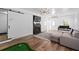 Bright living room with fireplace, hardwood floors, and putting green game at 608 Apache Trl, Woodstock, GA 30189