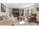 Cozy living room with a fireplace, built-in bookshelves, comfortable seating, and ample natural light at 608 Apache Trl, Woodstock, GA 30189