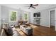 Cozy living room with hardwood floors, comfortable seating, and bright windows at 608 Apache Trl, Woodstock, GA 30189