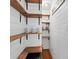 Walk-in pantry with custom wooden shelving, providing ample storage space at 608 Apache Trl, Woodstock, GA 30189