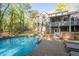 Inviting backyard with an in-ground pool and a wooden deck, perfect for outdoor relaxation at 608 Apache Trl, Woodstock, GA 30189