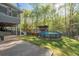 Backyard featuring above ground pool and open air structure with bar area surrounded by mature trees at 608 Apache Trl, Woodstock, GA 30189