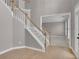 Bright foyer featuring hardwood floors, staircase with white railings, and an open doorway to another room at 1805 Hunters Moon Dr, Alpharetta, GA 30005