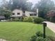 A lush front lawn and manicured landscaping frame this charming two-story home, enhancing its curb appeal at 2926 Summercrest Ln, Duluth, GA 30096