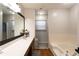 Bathroom boasts a double vanity, a large mirror and a combined tub and shower at 3874 Carriage Sw Ln, Conyers, GA 30094