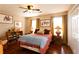 Comfortable bedroom featuring hardwood floors, neutral decor, and plenty of natural light at 3874 Carriage Sw Ln, Conyers, GA 30094