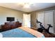 Bedroom featuring wood floors, natural light, a peloton bike, a dresser, and a ceiling fan at 3874 Carriage Sw Ln, Conyers, GA 30094